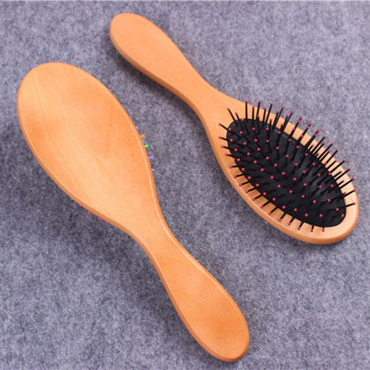 2 brosse à cheveux en bois, l'une posée à l'endroit, l'autre à l'envers. Forme ovale, picot couleur rose et fond noir, - PBS - Naturopathie & Zéro déchet